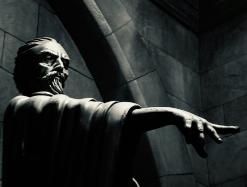 a black and white photo of a statue of a man