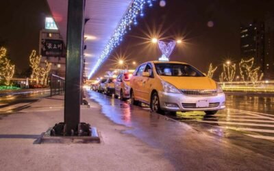 Des taxis jaunes attendent sous un pont décoré de lumières